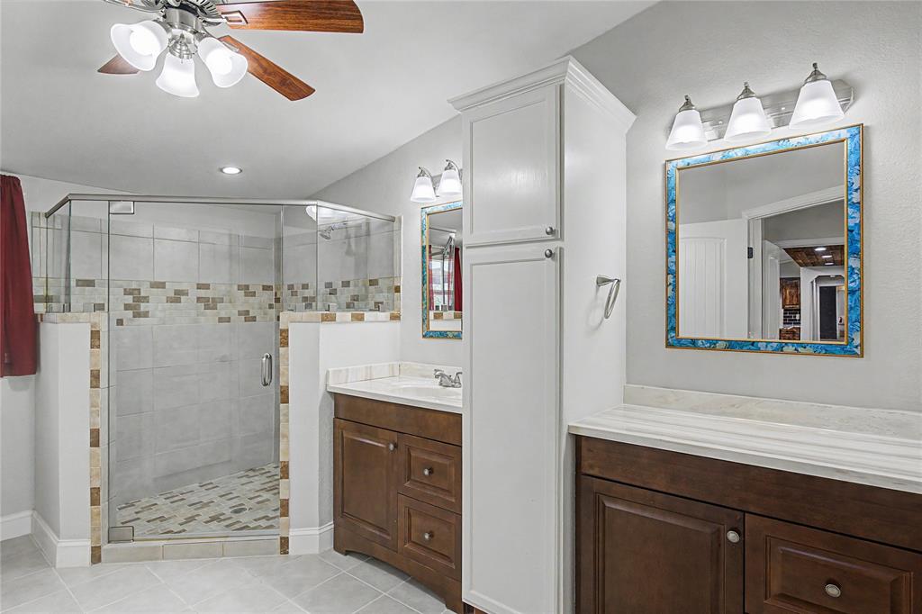 1701 Central Road Weatherford, TX 76088 - Photo 24 of 40 Primary ensuite bath with vanity, ceiling fan, recessed lighting, plenty of storage, an oversized walk in shower, and tile flooring.