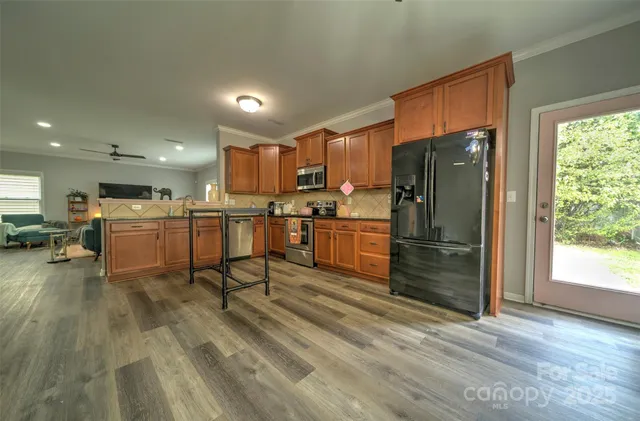 a kitchen with stainless steel appliances a refrigerator and a stove top oven