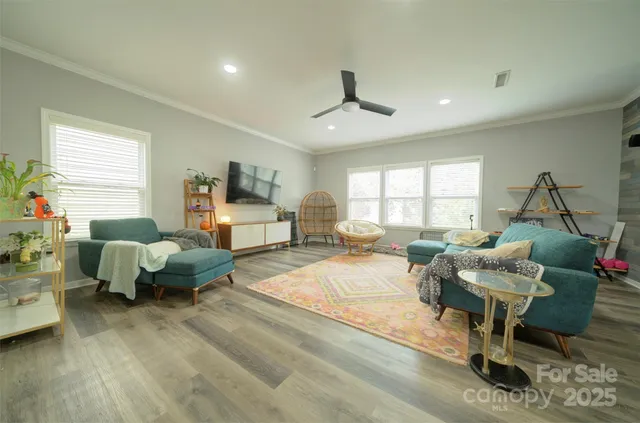 a living room with furniture chess table and a window