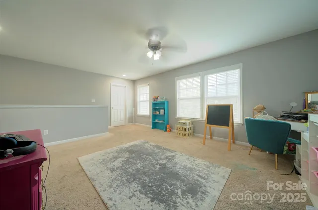 a view of a livingroom with workspace and a window