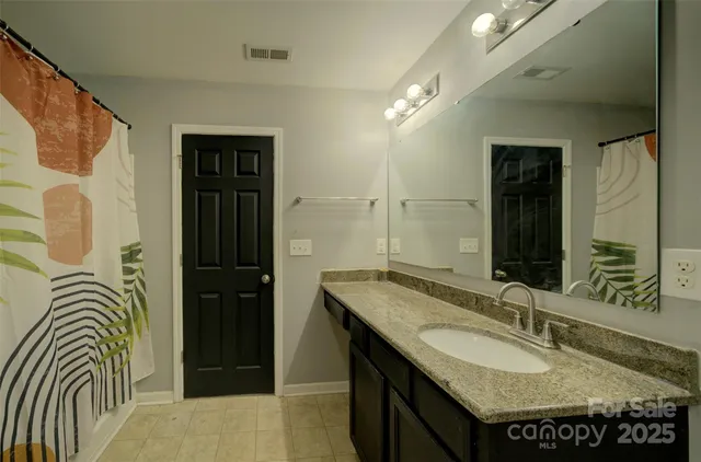 a bedroom with furniture and a flat screen tv