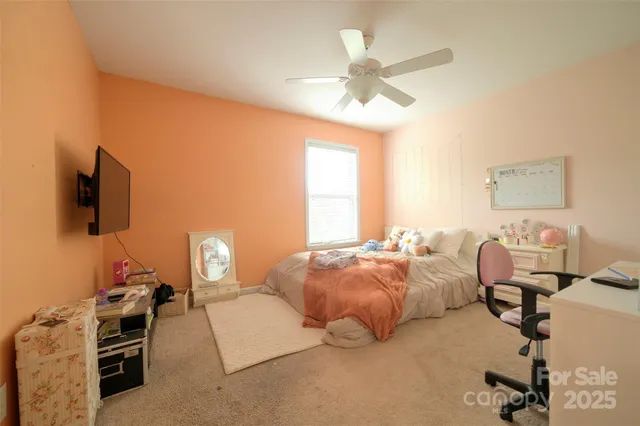 a bathroom with a granite countertop toilet and a sink