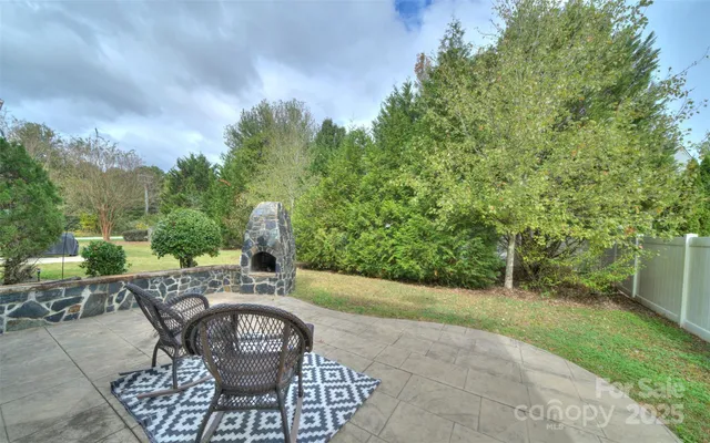 a view of a chairs and table in backyard of the house