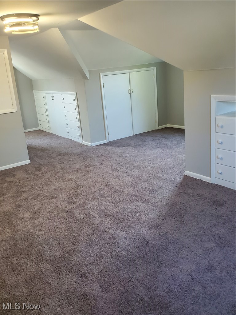 7007 Biddulph Road Brooklyn, OH 44144 - Photo 11 of 16 Additional living space with carpet flooring, baseboards, and vaulted ceiling
