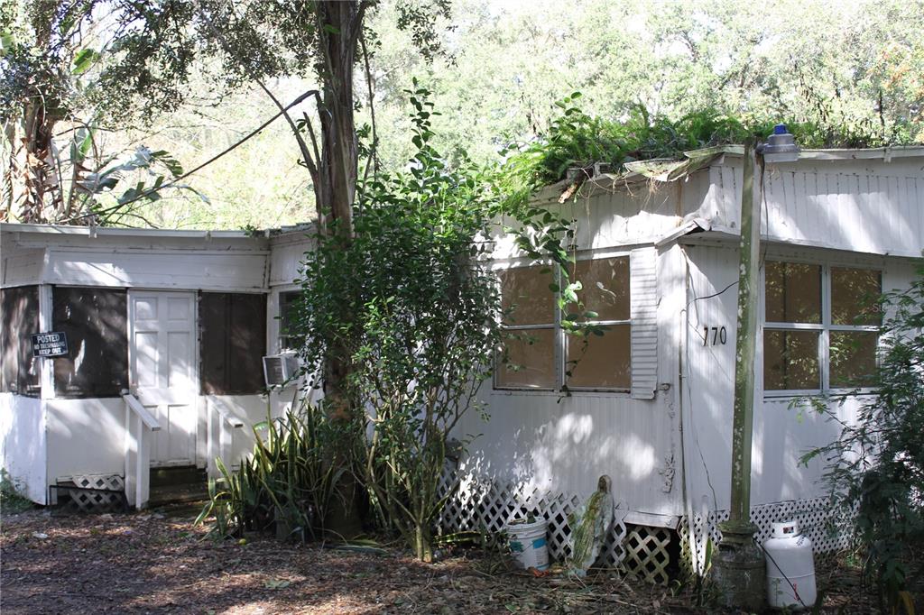 770 Snow Hill Road Geneva, FL 32732 - Photo 14 of 16 a front view of a house with a yard garage and outdoor seating