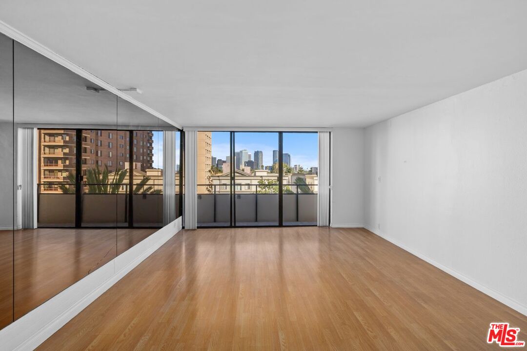10535 Wilshire Boulevard, Unit 801 Los Angeles, CA 90024 - Photo 1 of 53 a view of a big room with wooden floor and a floor to ceiling window
