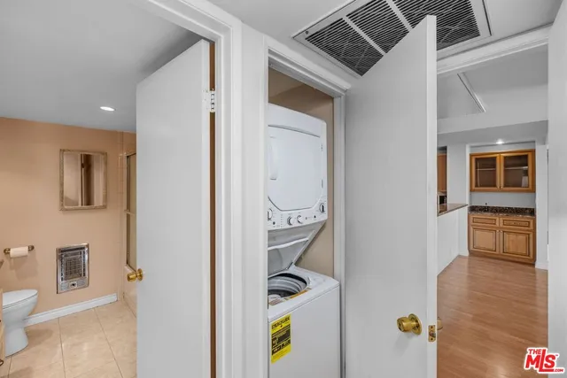 a view of hallway with furniture and wooden floor