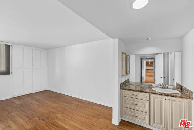 a view of kitchen with granite countertop cabinets and sink