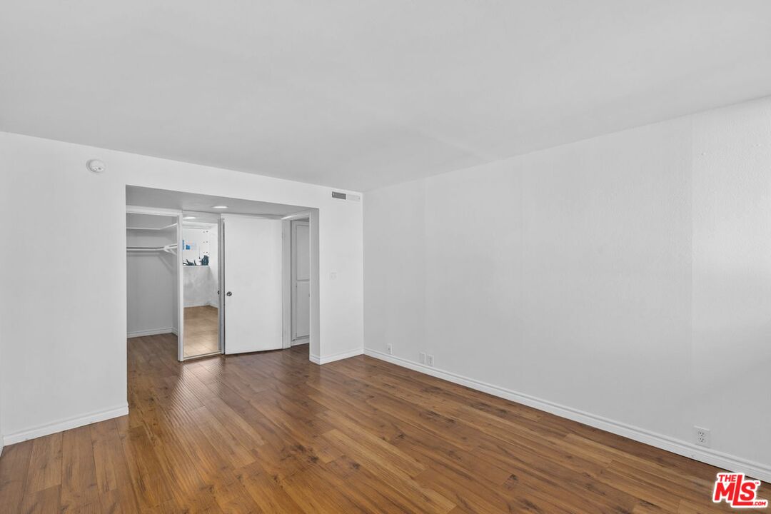 10535 Wilshire Boulevard, Unit 801 Los Angeles, CA 90024 - Photo 22 of 53 a view of an empty room and wooden floor
