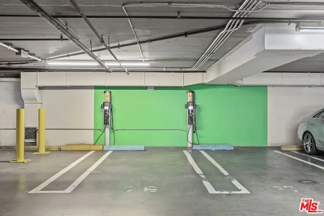 a view of a building with a bench under a large tree