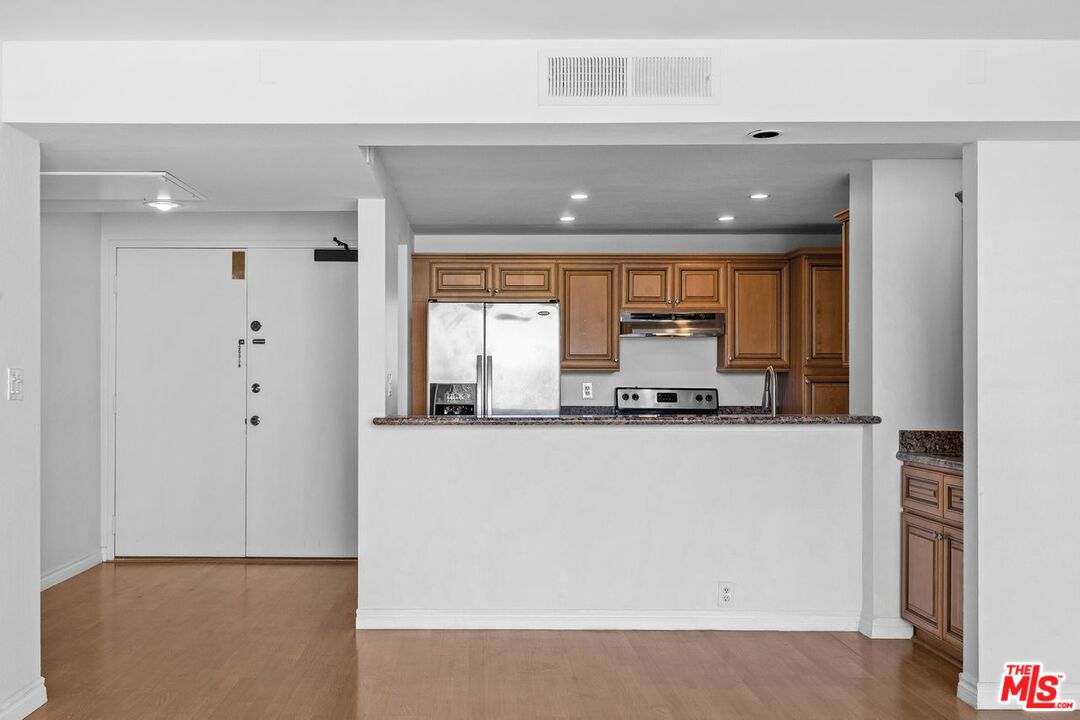 10535 Wilshire Boulevard, Unit 801 Los Angeles, CA 90024 - Photo 8 of 53 a living room with stainless steel appliances a large window