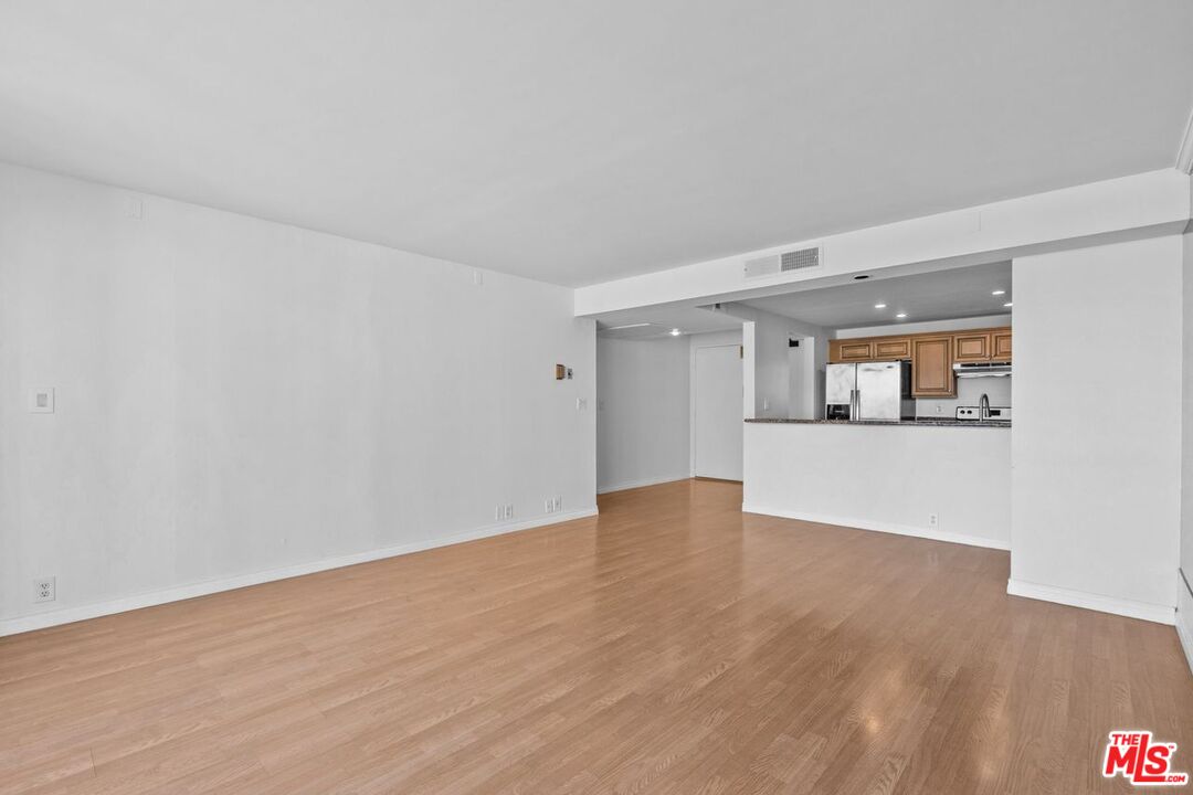 10535 Wilshire Boulevard, Unit 801 Los Angeles, CA 90024 - Photo 10 of 53 a view of empty room with wooden floor and cabinet