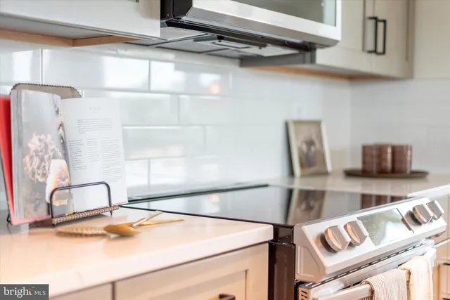 a kitchen with a sink and a stove top oven