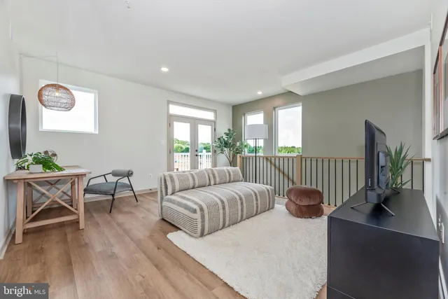 a bedroom with furniture and a wooden floor