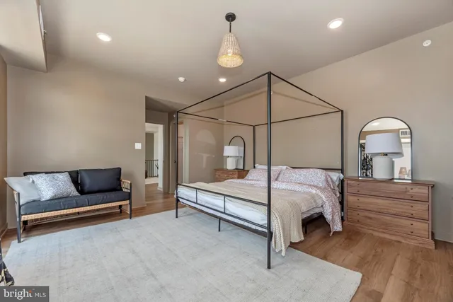 a bedroom with a bed couch and window