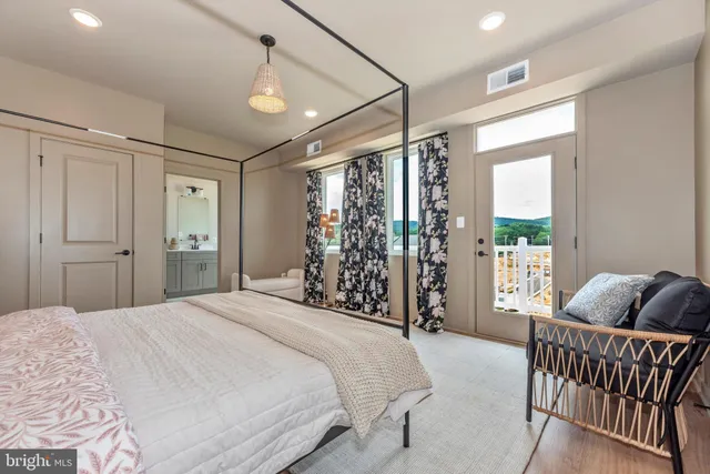 a bedroom with a large bed and a window