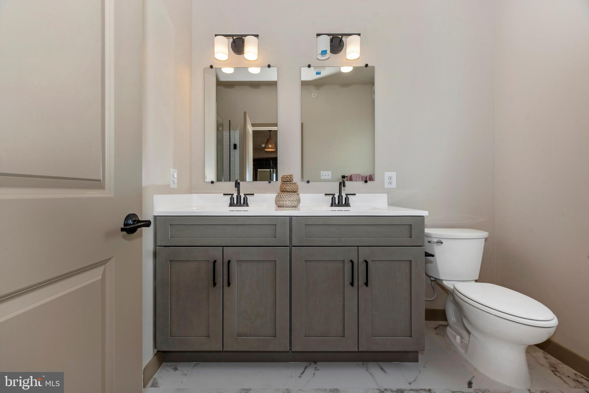 710 D Iron Frg Road Frederick, MD 21702 - Photo 28 of 37 a bathroom with a sink vanity and a toilet