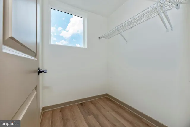 a view of a small space with wooden floor and windows