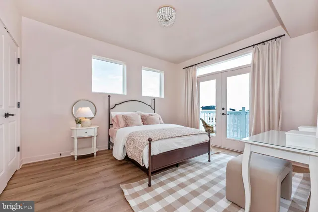 a spacious bedroom with a bed lamp and a large window