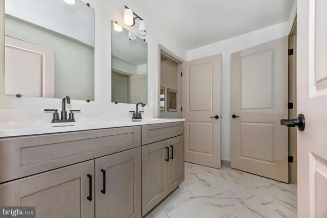 a bathroom with a double vanity sink mirror and