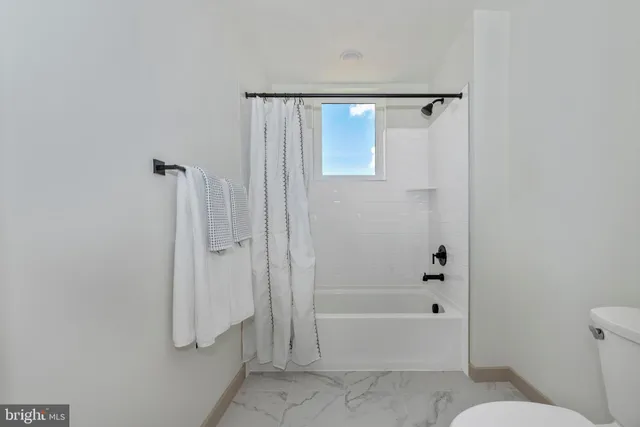 a bathroom with a shower and a toilet