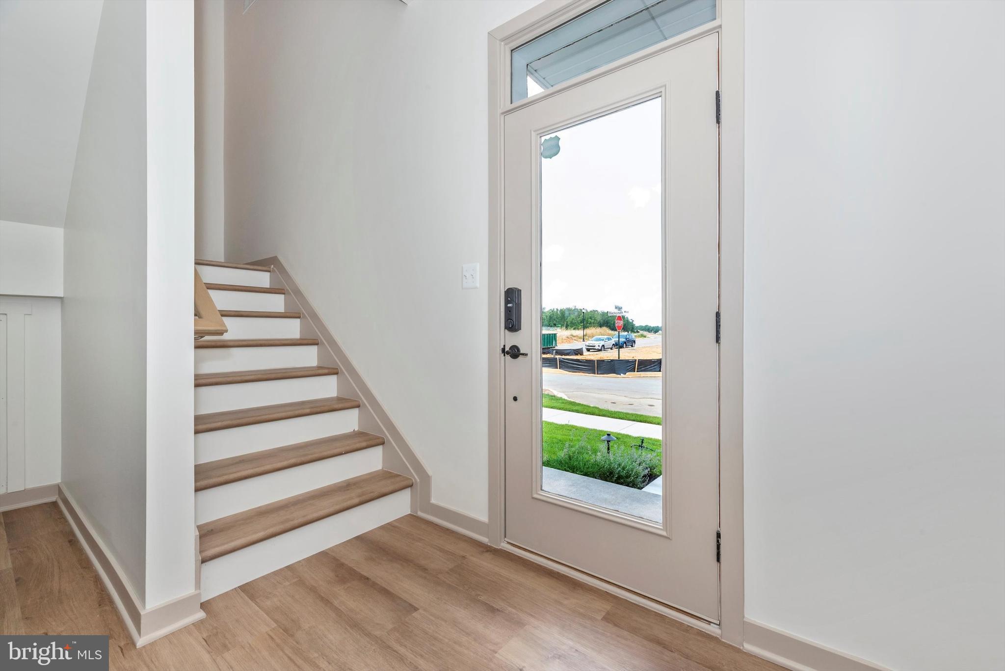 710 D Iron Frg Road Frederick, MD 21702 - Photo 4 of 37 a view of a hallway with wooden floor and entryway