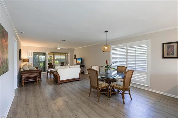 a view of a dining room with furniture window and wooden floor