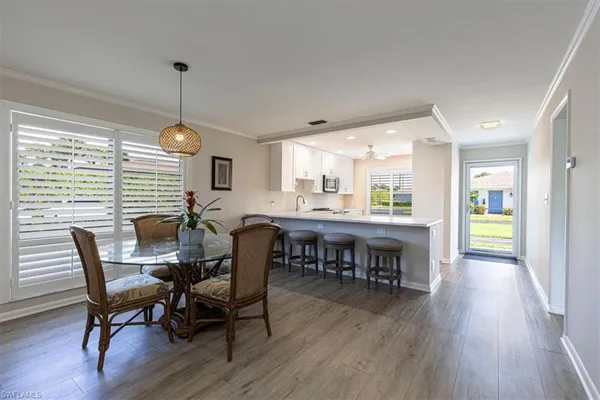 a view of a dining room with furniture window and wooden floor