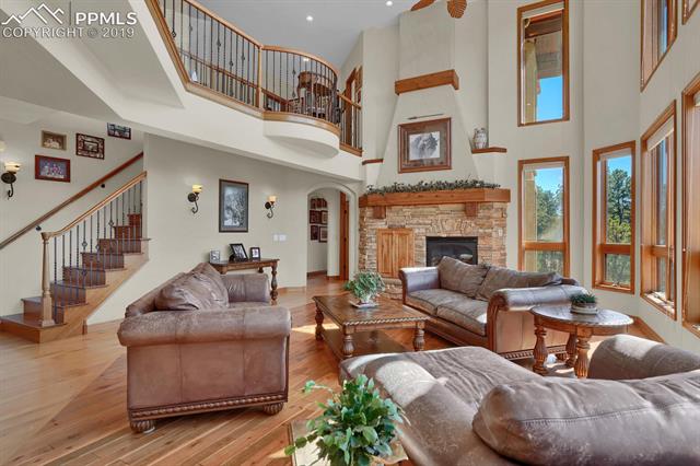 10980 Huntsman Road Colorado Springs, CO 80908 - Photo 7 of 35 Great room with expansive windows and amazing peak views!