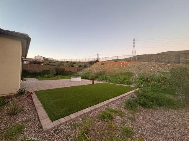 a view of a field with an ocean in the background