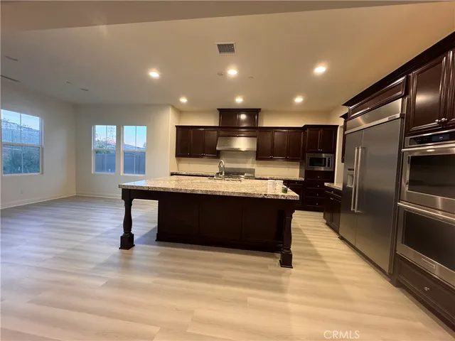 a kitchen with a refrigerator and a counter top space