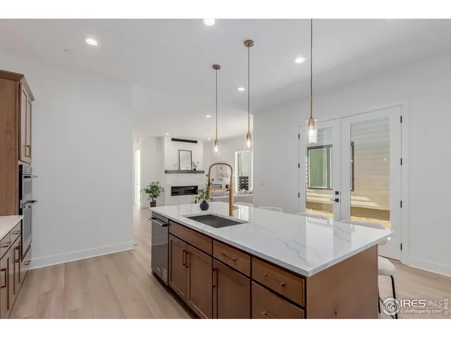 a kitchen with kitchen island a sink appliances and a counter top space