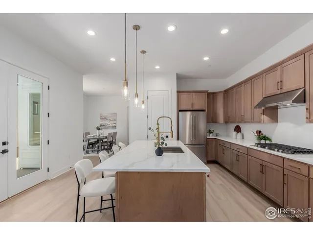 a kitchen with stainless steel appliances kitchen island granite countertop a sink and cabinets