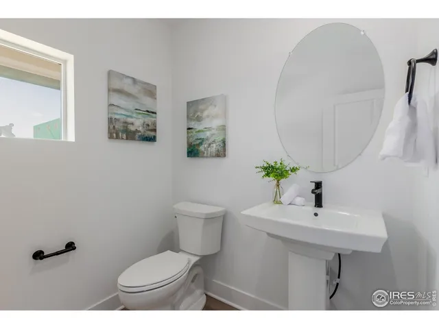 a bathroom with a sink mirror and toilet