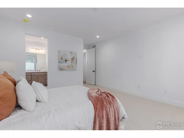 a bedroom with a bed and a painting