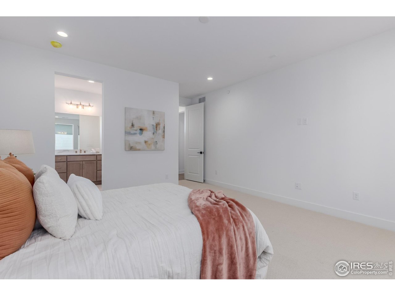 674 Apex Street Erie, CO 80516 - Photo 21 of 47 a bedroom with a bed and a painting