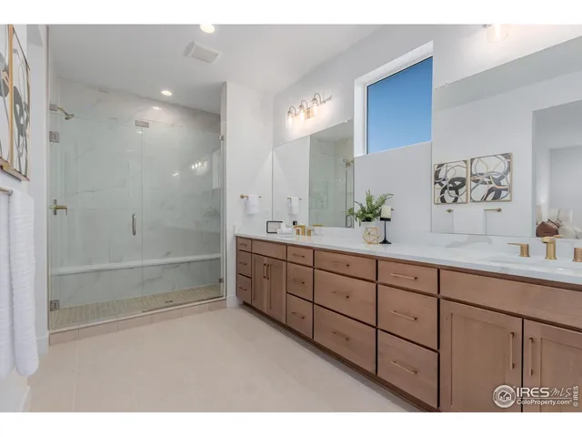 a bathroom with double vanity sink a two mirror a bathtub and shower