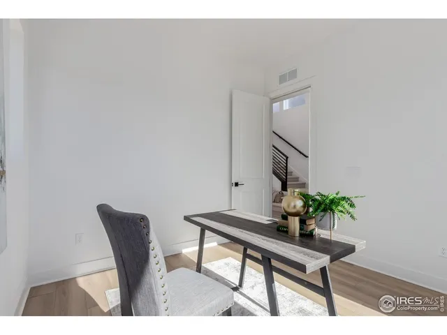 a view of a workspace room with wooden floor and chair