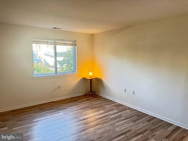 a view of wooden floor and windows in a room