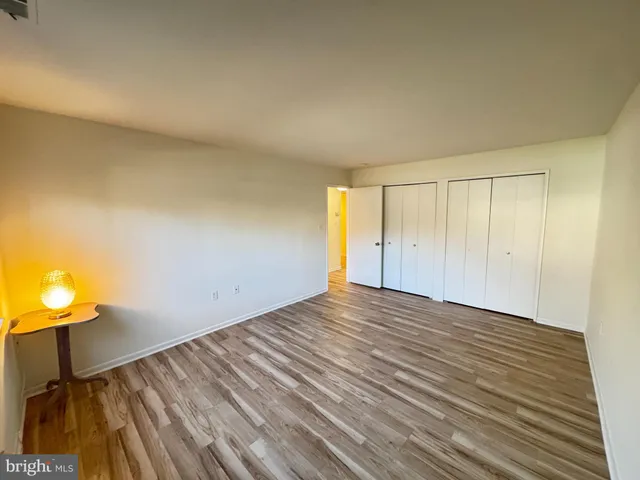 a view of a room with wooden floor and furniture