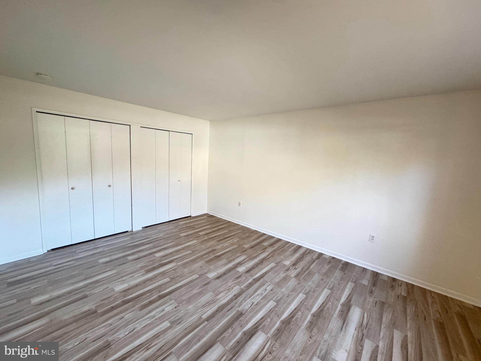 5033 Green Mountain Circle, Unit 2 Columbia, MD 21044 - Photo 18 of 40 Spacious room with modern wood flooring.