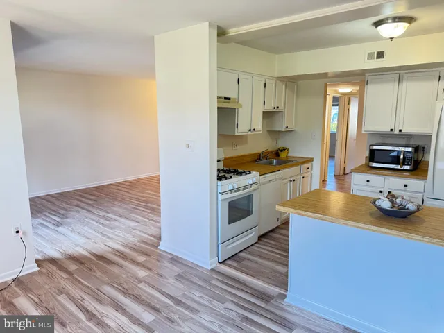 a view of an empty room and wooden floor