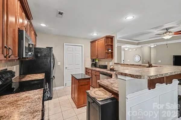 a kitchen with stainless steel appliances granite countertop a sink and cabinets