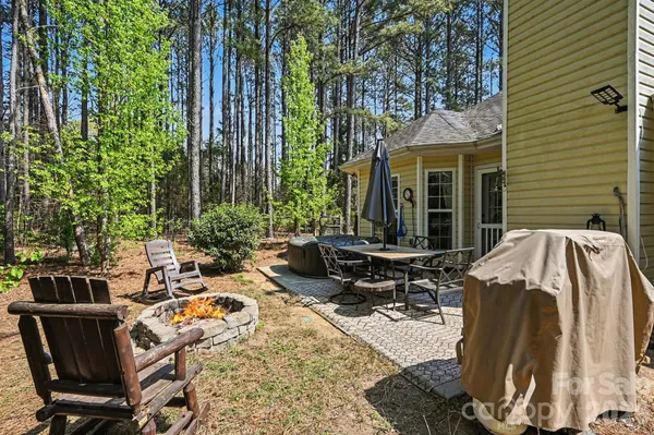 a view of a patio with table and chairs and potted plants