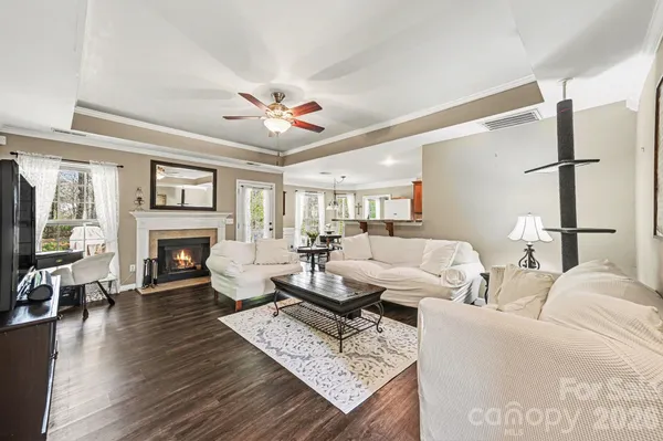 a living room with furniture a fireplace and a flat screen tv