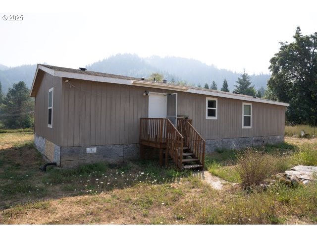 911 Tunnel Road Glendale, OR 97442 - Photo 4 of 29 a backyard of a house with barbeque oven fire pit and couches