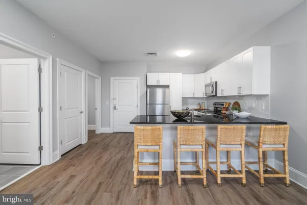 a kitchen with wooden floors and wooden cabinets