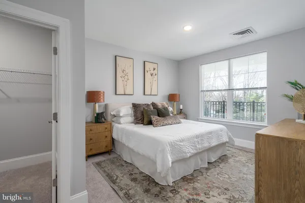 a bedroom with a bed and window