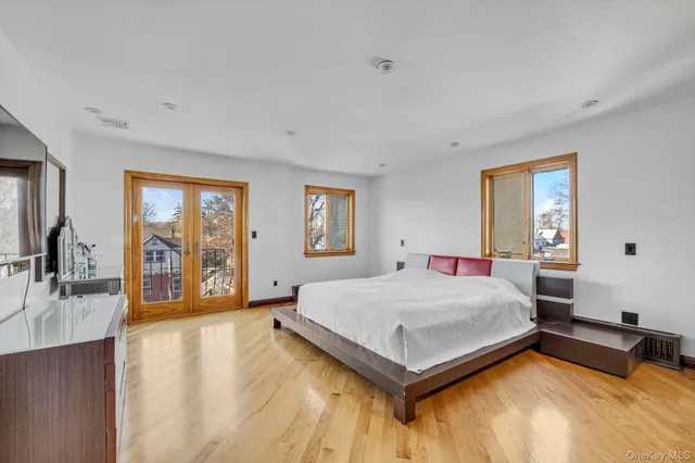 a bedroom with a large bed and a large window