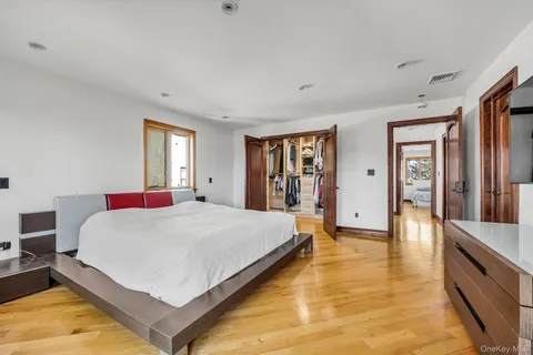 a bedroom with a large bed and a chandelier